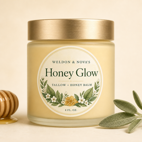 A glass jar of tallow with a gold lid and a cream-colored label reading 'Weldon & Nova's Honey Glow Tallow + Honey Balm 4 FL.OZ.